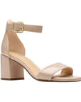 Women's Clarks Ezoria Mae Heeled Sandal in nude patent leather with ankle strap and block heel, perfect for weddings and dressy looks.