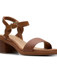 Women's Clarks Jaylan Ray Heeled Sandal in brown leather with woven toe strap and block heel for a chic, comfortable look.