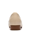 Beige loafer shoe heel with low stacked heel.