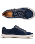 Pair of Denim sneakers with silver side zipper, navy laces, Clarks logo'd tan footbed, white midsole and brown outsole.
