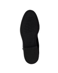 Black rubber outsole of tall boot.