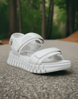 White Ecco Gruuv Sol women's walking sandal shown outdoors, highlighting its stylish design and durable sole for active wear.