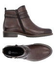 Pair of Women's brown leather ankle boots with side zipper, buckle strap detail, black Remonte logo'd footbed and low heel.