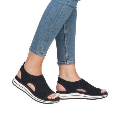 Model wearing black Remonte D1J55 sporty backstrap sandals with jeans, highlighting the casual and orthotic-friendly fit.
