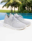 Light grey Women's Remonte R6712 Slip-On Sneakers placed by a poolside, emphasizing breathable textile and sporty design.