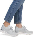 Model wearing light grey Women's Remonte R6712 Slip-On Sneakers with jeans, showcasing casual style and comfort fit.