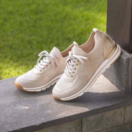 Beige Women's Remonte R6712 Slip-On Sneakers displayed outdoors, highlighting breathable knit design and sporty silhouette.