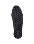 Diamond pattern outsole of black ankle boot with Rieker logo stamped in heel.