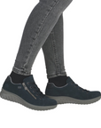 Navy blue casual shoes worn with gray jeans.