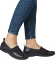 Model wearing Women's Rieker L1790 leather loafers in black, styled with jeans for a casual, comfortable everyday look.