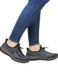 Model wearing blue-grey bungee lace Slip-On Sneakers with jeans.
