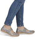 Silver Mary-Jane shoes worn with blue jeans.