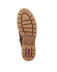 Tan deep treaded outsole of winter boot with red Rieker logo on heel.