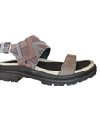 Multicolored sandal with patterned stripes straps and black outsole.