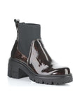 A marbled dark brown patent heeled Chelsea boot with elastic side goring, a heel pull tab, and thick lugged outsole.