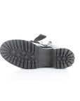 Black treaded outsole of combat boot.