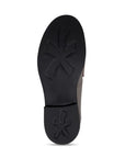 Black treaded outsole with flower pattern on ball and heel of shoe.