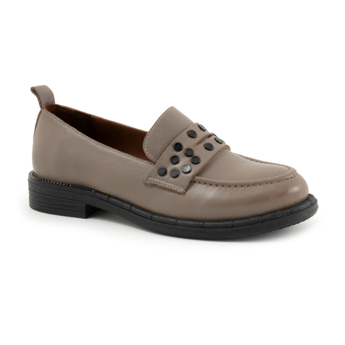 Beige loafer shoe with black circle embellishments on strap and black think outsole.