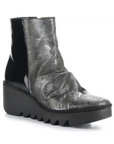Metallic black Women's FLY London Baan Wedge Bootie with glossy leather upper, rugged sole, and modern wedge heel for edgy fall looks.