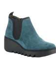 Women's FLY London Byne Wedge Boot in teal suede with black elastic side panels and chunky wedge sole, perfect for stylish seasonal wear.