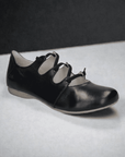 Josef Seibels Fiona 04: Black slip-on flat with crisscross straps and a durable rubber outsole.