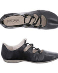 Black leather womens shoe with cut-out design, low heel, and rubber outsole shown in views.