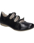 Black leather shoes with a rubber outsole and crisscrossed elastic straps.