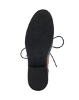 Black light treaded pebbled pattern outsole of oxford shoe.