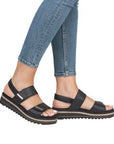Model wearing black Backstrap Sandals with jeans.