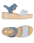 A pair of light blue platform sandals with dark blue backstrap, tan Remonte logo'd footbed and a woven multicolor striped wedge sole.