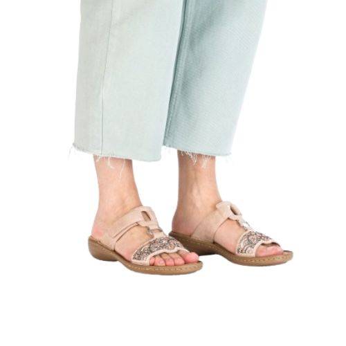 Model wearing beige Women's Rieker 608K2 Slide Sandals, perfect for casual outfits with a blend of comfort and elegance.