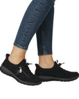Black Women's Rieker L32F1 Slip-On Sneakers worn with jeans, showcasing stylish fit and flexible, cushioned sole for everyday use.