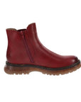 Profile of a red Chelsea boot with side zipper, accent tan stitching and a lugged outsole.