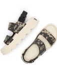 Pair of Ankle strap Sandals with camouflage straps and thick white lugged outsole.