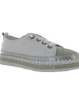 A Bernie Mev sneaker in white leather with silver rhinestones covering the toe and midsole, white laces and a white platform outsole attached with large white stitching.