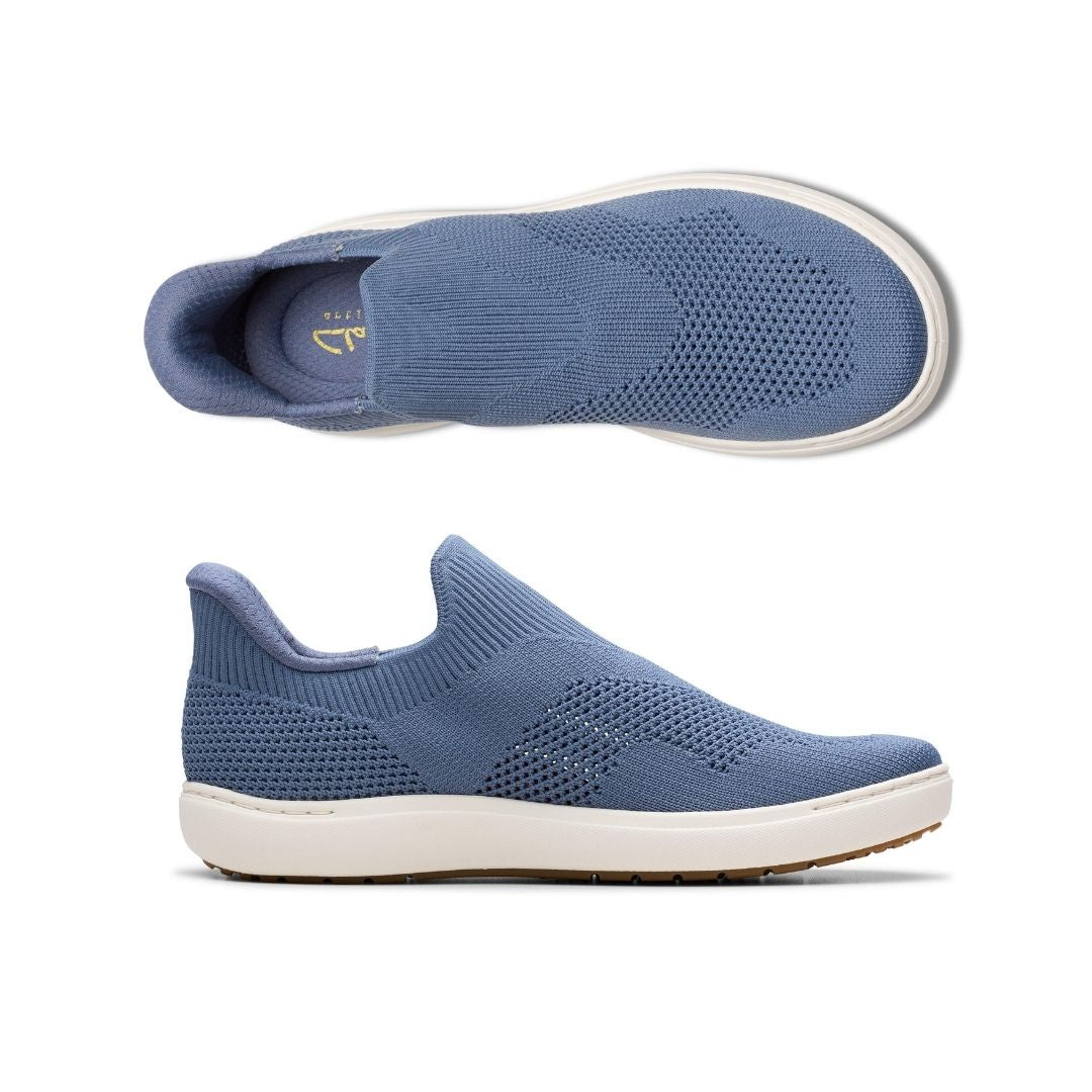 Top and side views of blue Clarks Nalle Step Knit Sneaker for women. Breathable knit fabric and step-in design for effortless wear and support.