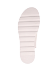White deep lined outsole of sandal.