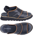 Pair of Navy sandals with brown stitching accents, elastic backstrap, navy Django & Juliette logo'd footbed and navy outsole.