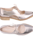 Pair of Soft gold leather oxfords with d’Orsay side cutouts, tan Django and Juliette logo'd footbed and low stacked heel.