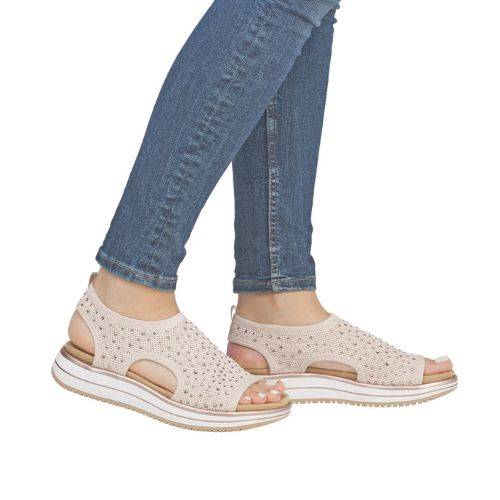 Model wearing beige Remonte D1J55 sporty backstrap sandals with jeans, showcasing the lightweight and stylish flat sandal design.