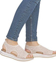 Model wearing beige Remonte D1J55 sporty backstrap sandals with jeans, showcasing the lightweight and stylish flat sandal design.