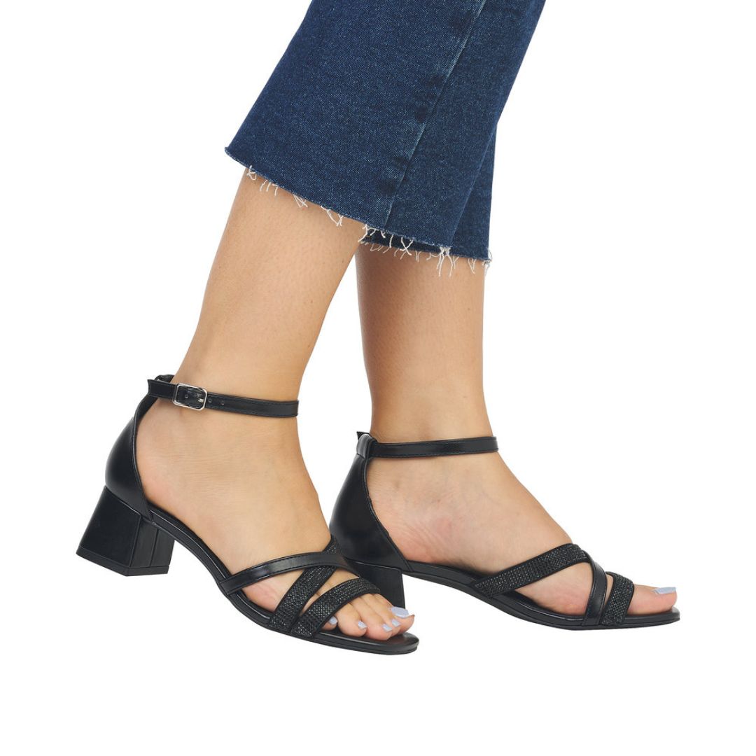Model wearing black Remonte D1L51 sling-back heels with ankle strap and block heel, perfect for casual or dressy outfits.