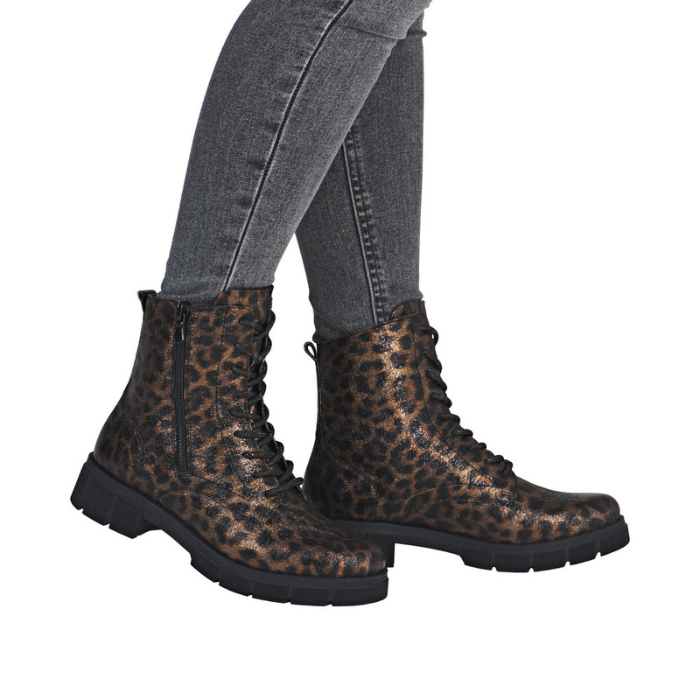 Leopard print boots worn with gray jeans.