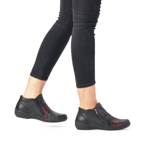 Model wearing Women's Remonte R7674 Ankle Boots styled with black jeans, highlighting the boot's comfort, flexibility, and fall-ready design.
