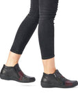 Model wearing Women's Remonte R7674 Ankle Boots styled with black jeans, highlighting the boot's comfort, flexibility, and fall-ready design.