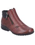 Red ankle boot with black outsole and outside zipper closure.
