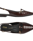 Pair of dark brown crocodile-embossed slingback flat shoes with a pointed toe, black Clark's logo'd footbed and gold-tone buckle details.