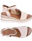 Pair of beige sandals with slingback and open toe d'Orsay style upper with gold buckle, white and gold lined wedge midsole and tan Bueno logo'd footbed.s