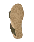 Beige outsole of cork wedge sandal with green straps showing and circle tread pattern with Mephisto stamped in.