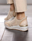 Rear view of the Remonte D0T08 slip-on sneaker on foot, showcasing the cushioned wedge heel and sleek design.